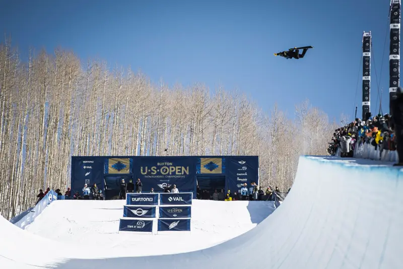 Snowboarder high above the halfpipe wall at the Burton US Open