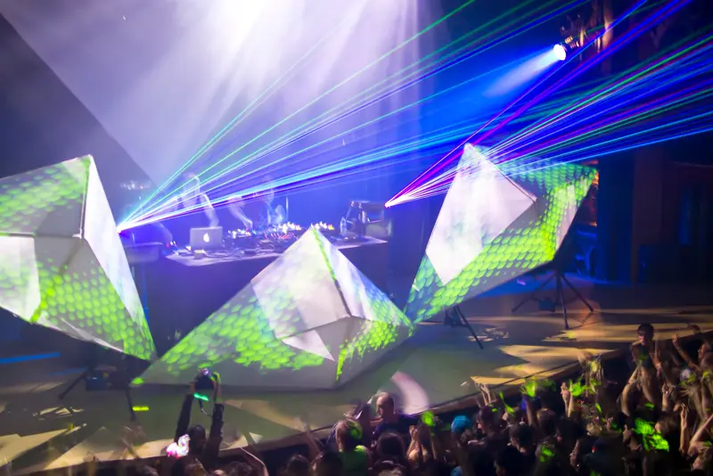Concert stage with laser show and geometric set pieces over the crowd