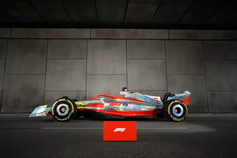 Formula 1 show car with iridescent livery in a dark concrete garage
